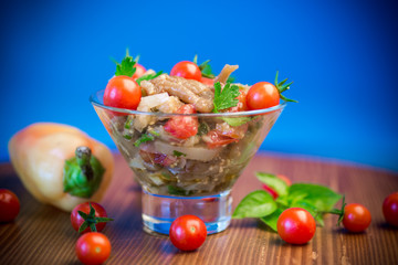 A warm salad of baked eggplant and peppers with cherry tomatoes