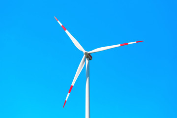 Wind turbine at blue sky, renewable energy and ecology concept
