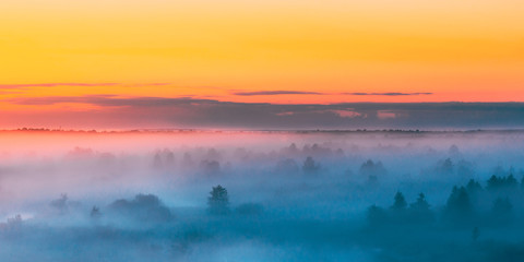 Sunrise Over Misty Landscape. Scenic View Of Foggy Morning Sky A