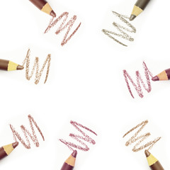 Cosmetics isolated on white background. Macro nude trend colors pencils, strokes (smear).