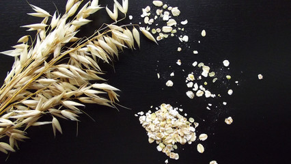 Oats and wheat on a black background. © NADEZHDA