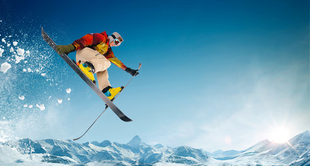 Skiing. Jumping skier. Extreme winter sports. - obrazy, fototapety, plakaty