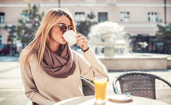 Young woman sitting in the cafe and drinking coffee. Lifestyle concept