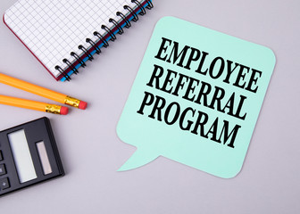 Employee Referral Program. Paper speech bubble on a gray table