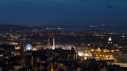 Fototapeta na wymiar Edinburgh City Skyline with Christmas Market lit up at night
