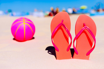 Flip flops, beach balll on the sandy beach. Summer vacation concept