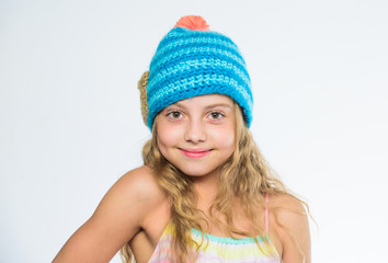 Difference between knitting and crochet. Fall winter season accessory. Free knitting patterns. Knitted hat with pompon. Girl long hair happy face white background. Kid wear warm soft knitted blue hat