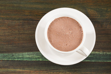 Delicious cup of Colombian chocolate - Wooden background