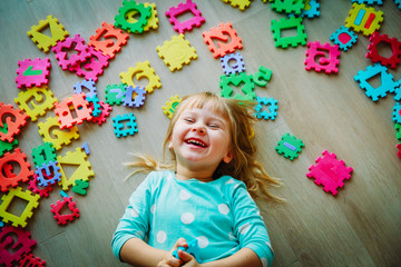 little girl playing with puzzle, early education