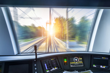 Driver's cab of speed passenger train, view of the railway bridge with the effect of speed motion...