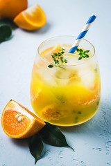 Refreshing clementine mocktail in glass. Selective focus, space for text.