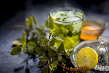Close up of Herabal drink or Basil lemonade  in a transparent glass  with raw basil,raw honey,ice...