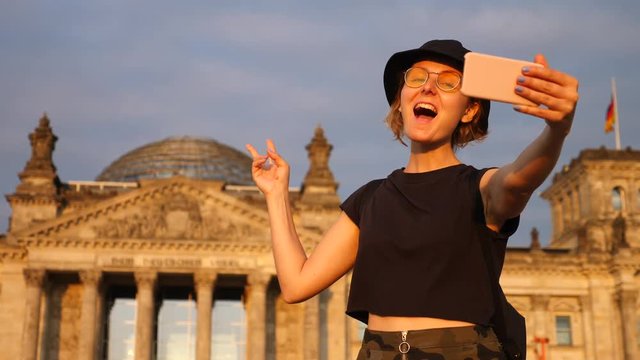Young Woman Traveler Taking Selfie With Phone At Tourist Attraction Traveling in Europe.