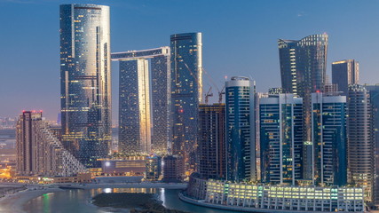 Buildings on Al Reem island in Abu Dhabi day to night timelapse from above.