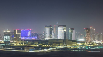 Obraz na płótnie Canvas Buildings on Al Reem island in Abu Dhabi night timelapse from above.