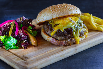 delicious fresh homemade burger on dark background