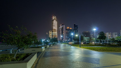 Fototapeta na wymiar Skyscrapers in Abu Dhabi Skyline at night timelapse hyperlapse, United Arab Emirates