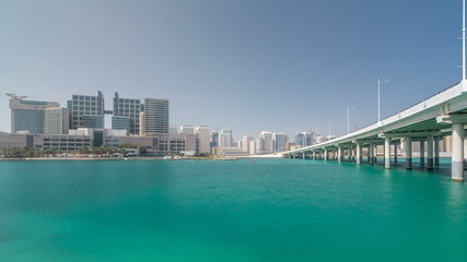 Modern buildings in Abu Dhabi skyline timelapse hyperlapse with mall and beach.