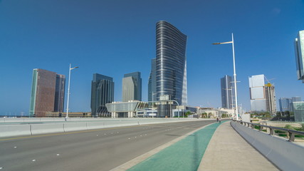 Obraz na płótnie Canvas Modern buildings in Abu Dhabi skyline timelapse hyperlapse with waterfront.