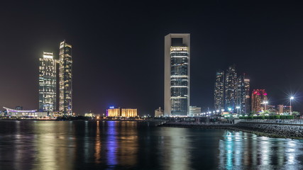 Panorama view of Abu Dhabi Skyline and seafront at night timelapse, United Arab Emirates