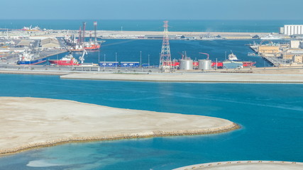 Big cargo ship at industrial port timelapse aerial fiew from above at evening in Abu Dhabi