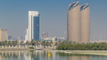 View of skyscrapers skyline with Al Bahr towers in Abu Dhabi timelapse. United Arab Emirates