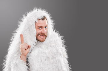 Obraz premium Caveman in animal skin on isolated background shows thumb up