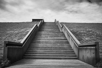 wooden stairway to heaven, black and white photo of a stairway over the dike in Petten, North Netherlands