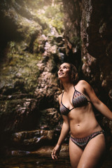 Woman admiring the view from a pond in jungle