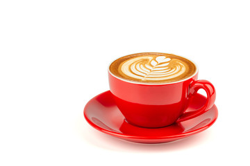 Side view of hot latte coffee with latte art in a bright red cup and saucer isolated on white...