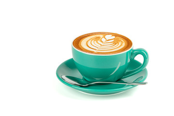 Side view of hot latte coffee with latte art in a green cup and saucer isolated on white background...