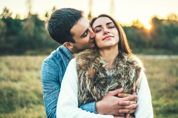 Happy couple in love relaxing in the field.