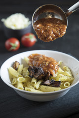 penne pasta on dark background