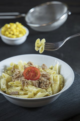 penne pasta on dark background