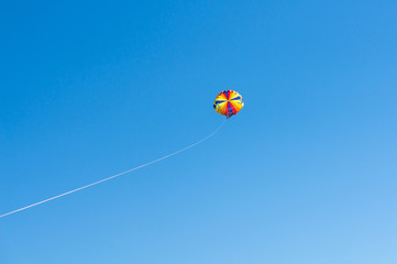 Happy couple Parasailing in Dominicana beach in summer. Couple under parachute hanging mid air. Having fun. Tropical Paradise. Positive human emotions, feelings, family, children, travel, vacation.