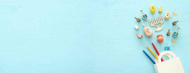 Top view image of jewish holiday Hanukkah background with traditional spinnig top, menorah (traditional candelabra) and candles.