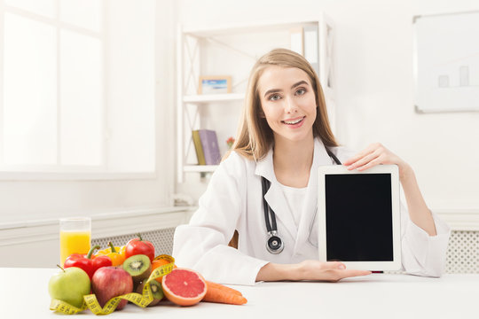 Doctor nutritionist holding digital tablet