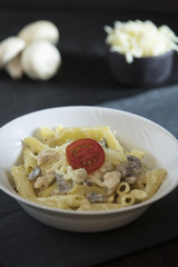 penne pasta on dark background