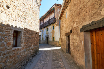 Fototapeta na wymiar Narrow street in the historic town of Orbaneja del Castillo