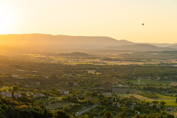 Hot-Air Balloon rising over French countryside at sunrise, Provence, France