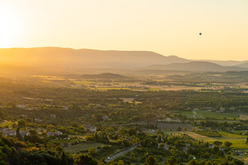 Fototapeta premium Hot-Air Balloon rising over French countryside at sunrise, Provence, France