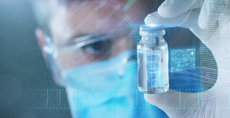 A doctor or scientist in laboratory holding a syringe with liquid vaccines for children or older...