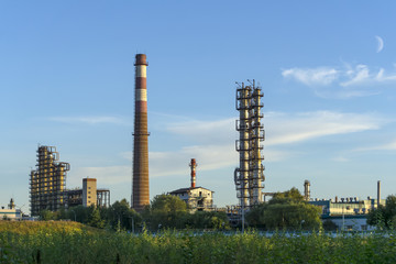 industrial landscape with packed distillation columns and heating furnace in a chemical factory. ..