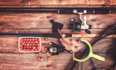 Fishing tackle on a old wooden table. Sport and recreation concept