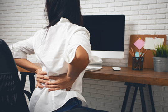 Business Woman Suffering From Back Pain In Office Home