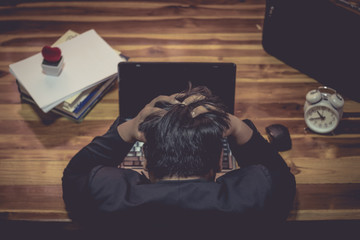 A man are stressed in the work. When the malfunction by removing the hands clasping head..