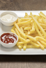 french fries wit ketchup over white plate
