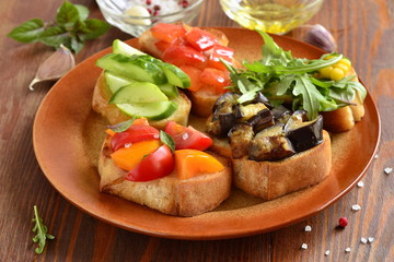 Various crostini with vegetables and herbs