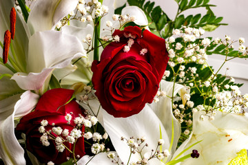 festive bouquet of roses and lilies in red and white colors