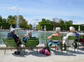 Older people resting near the fountain in France